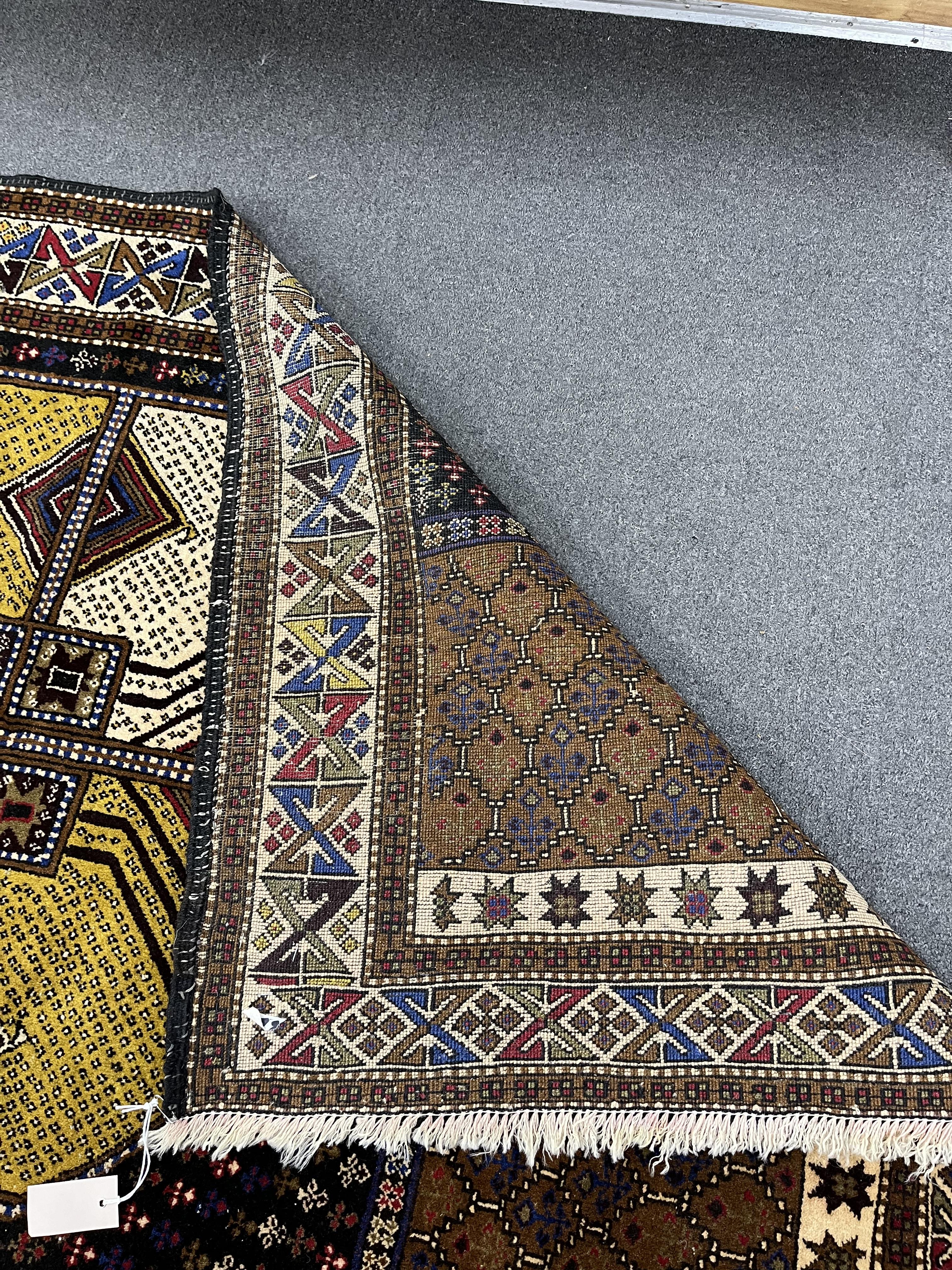 A Belouch geometric polychrome rug with central octagonal medallion, 202 x 113cm